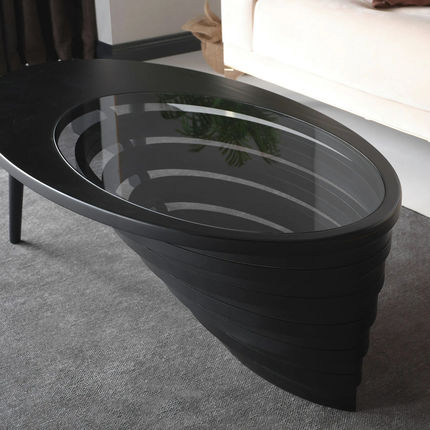 Designer center table with minimalist teardrop outline