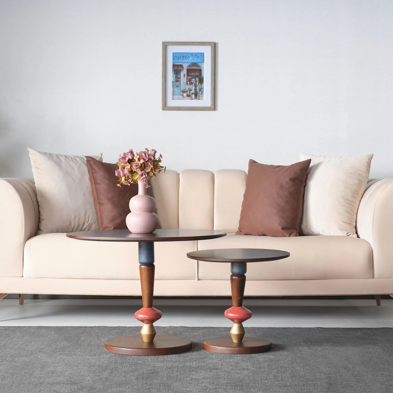 Pair of round wooden accent tables with colorful stems