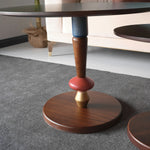 Modern whimsical round tables with red and gold bases