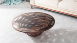 Petal-shaped wooden coffee table with artistic curved base and glossy inset glass top.