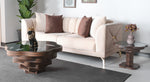 A round, floral-inspired coffee table with a layered walnut design and a tempered glass top, placed in a modern living room setting.