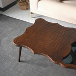Contemporary designer table with glass top and asymmetric legs