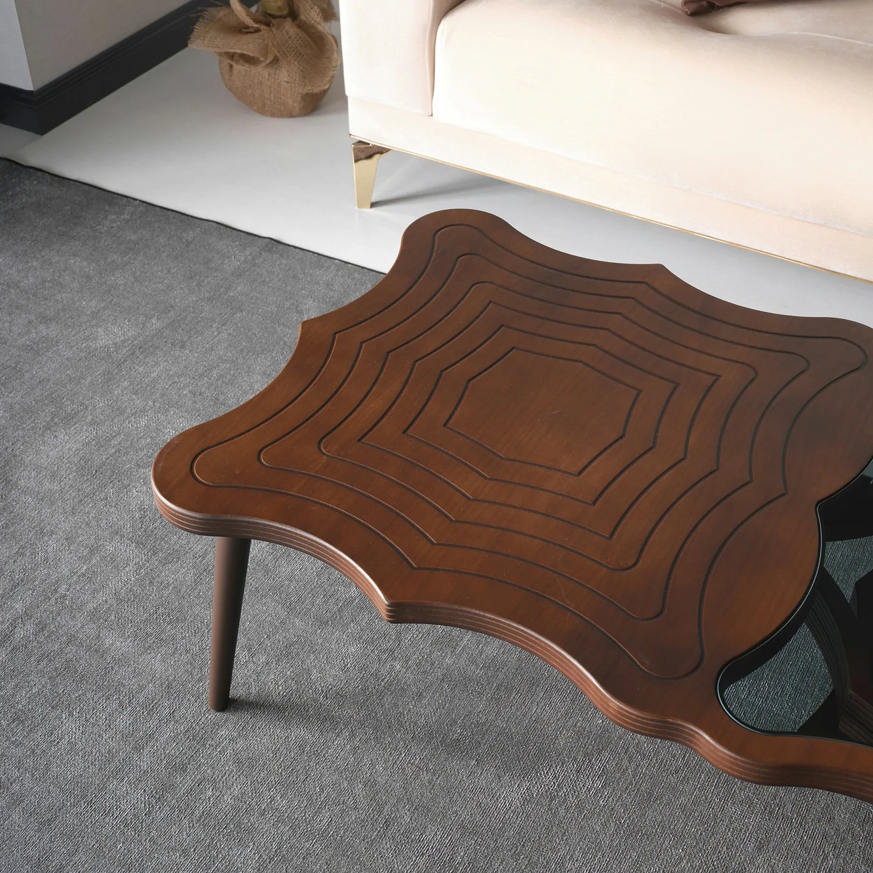 Contemporary designer table with glass top and asymmetric legs