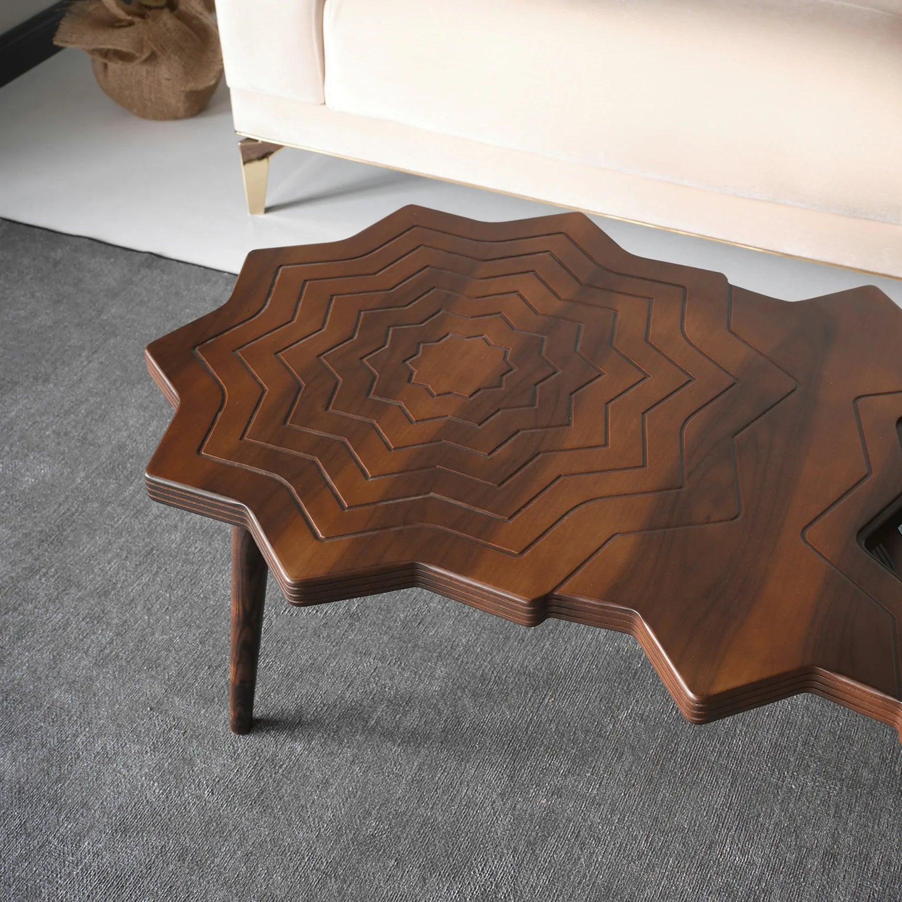 Geometric coffee table with engraved wooden starburst pattern