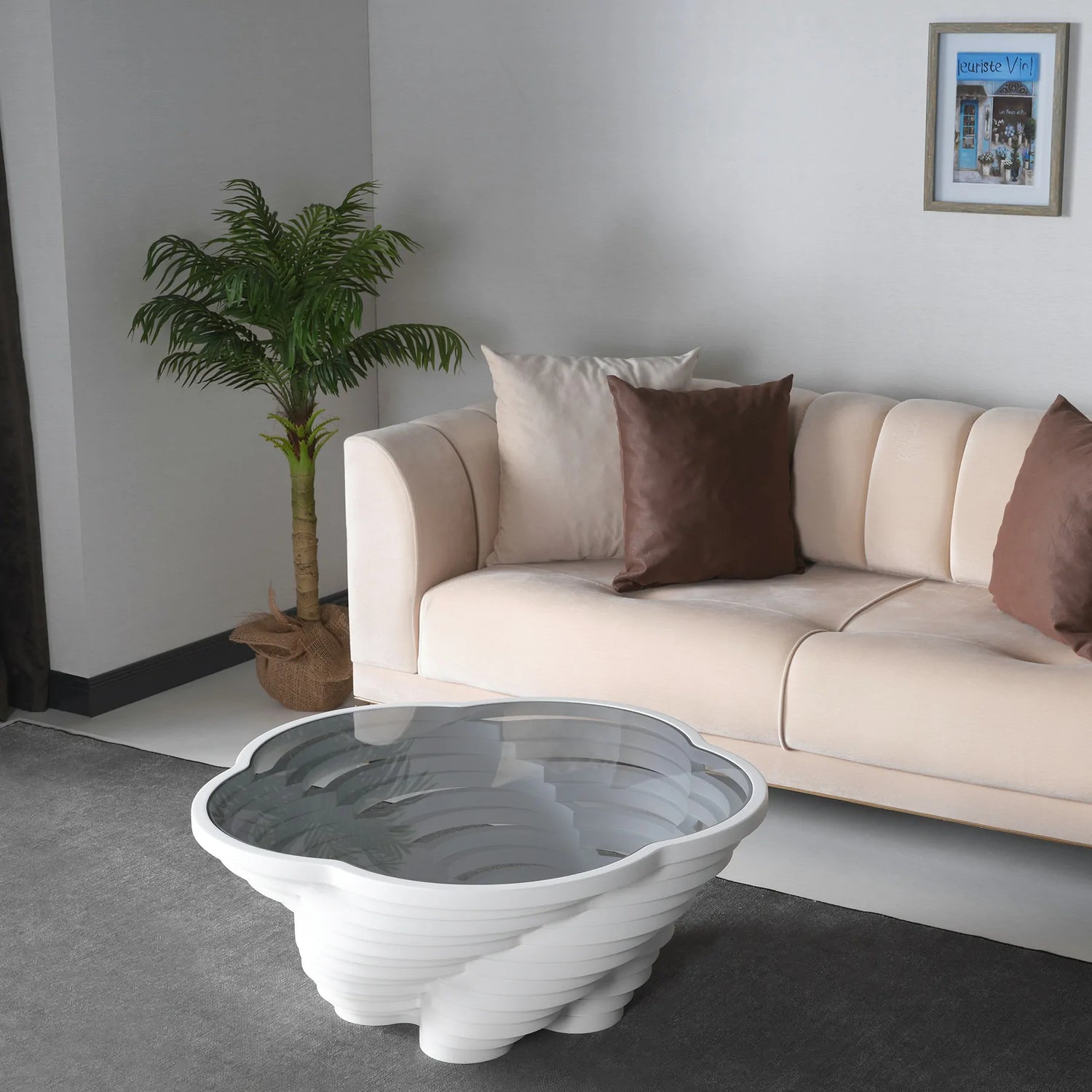 White sculptural coffee table with vortex-shaped base