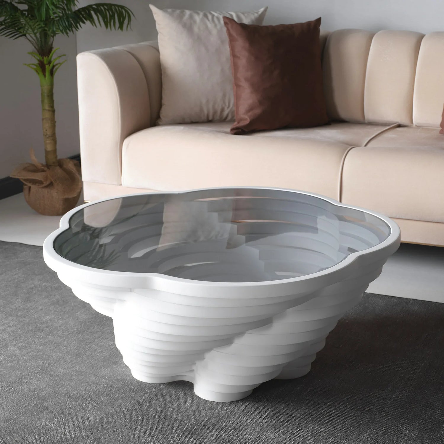 A modern, multi-tiered white coffee table with a glass top, designed by Papella Design, positioned in a living room setting.