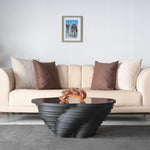 Modern designer table with deep black finish and glass top